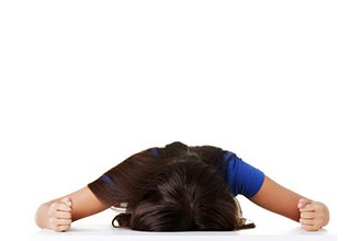 Teenager with head on table
